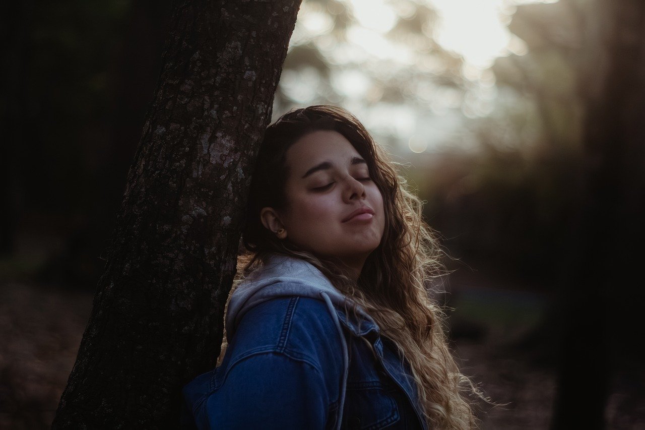 Woman in forest light - memory reconsolidation trauma therapy healing